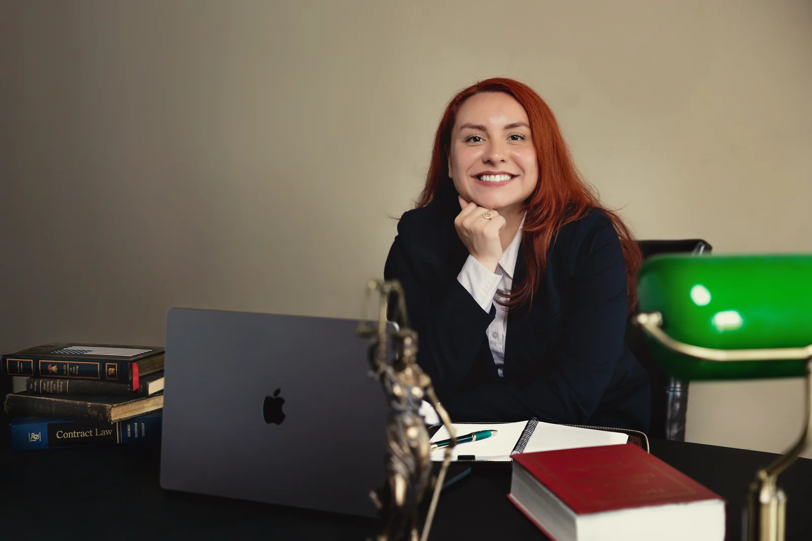 Sara Memi seated at her desk